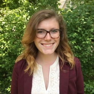 Here's the alt text for the image:

Rentable - Woman with glasses smiles in front of leafy greenery